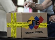 A woman casts her vote during the Venezuelan opposition's primaries to choose candidates for the September congressional election