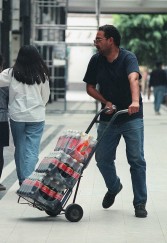 A man transports bottles of Coca Cola in a central street in Mexico City