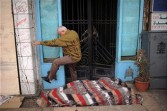 Egyptian man jumps over a protestor sleeping outside his front door
