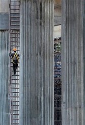 Indian engineer climbing a pillar on a section of the Bangalore Metro Rail Project that is under construction