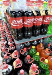 Bottles of Coca-Cola are displayed on the shelves of a store in Beijing