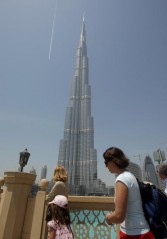 Tourists look at Dubai's Burj Khalifa