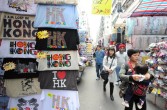 Shoppers walk past stalls at the 'ladies market' in Hong Kong