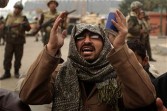 An Egyptian anti-government demonstrator and a member of the Egyptian Muslim Brotherhood movement prays in front of Egyptian soldiers at Cairo's Tahrir square on February 7, 2011 on the 14th 