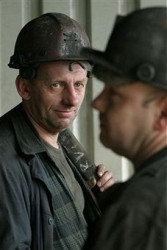 Polish coal miners chat before descending underground