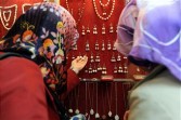 Turkish women look at gold earrings