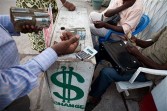 A man changing a 200 USD bank note in Congolese Francs 