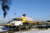 An oil tanker truck waits to unload at a terminal owned by the Canadian oil company Hurricane Kumkol Munai December 19, 2002