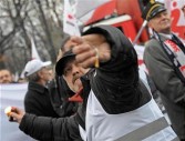 Solidarity trade unionist throw firecrackers during a demonstration against government reform plans in front of the government building on November 20, 2008 in Warsaw.