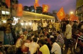 Commnist Party of India, Marxist (CPIM) supporters wait at the road side to join a victory rally in Calcutta, 14 May 2004