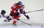 Jakub Voracek (C) of the Czech Republic fights for a puck with Mikelis Redlihs of Latvia during the IIHF Ice Hockey World Championships group D match in Bratislava,
