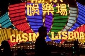 People walk past the illuminated Casino Lisboa in Macau, China, on Thursday, Jan. 27, 2011. 