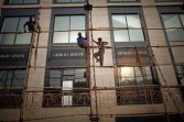 Construction workers prepare a temporary shelter for an upcoming fashion event at the DLF Emporio luxury shopping center in New Delhi, India, on Thursday, July 8, 2010.