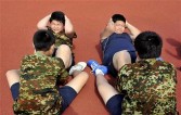 Obese Chinese boys do sit-ups as they take part in a weight-lost camp in Shenyang, northeast China's Liaoning province, on August 3, 2010.