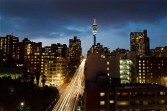 The Telkom branded telecommunications tower, center, is seen at dusk in the Hillbrow district of Johannesburg, South Africa, on Tuesday, April 19, 2011. 