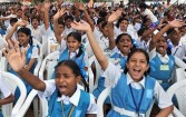 Indian school children raise their hands during a 'Wealth Out of Waste ' (WOW) programme to commemorate National Recycling Day in Hyderabad on July 1, 2010. 