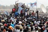 Supporters wave posters and banner in support of the presidential candidate of Congress for Progressive Change, retired General Mohammadu Buhari, during the presidential campaign rally of the leading opposition retired General Mohammadu Buhari in Kaduna on March 2, 2011.