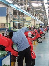 Workers put the finishing touches to new Piaggios inside the Binh Xuyen industrial park in Vinh Phuc province, north of Vietnam on June 24, 2009. 
