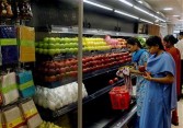 Indian employees polish fruit before placing it on shelves as they prepare the Reliance Fresh Store Outlet in Hyderabad, 02 November 2006.