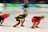 China's Yang Zhou (R), Germany's Aika Klein and Hungary's Erika Huszar compete in the Women's Short Track Speedskating 1000m heats at the Pacific Coliseum in Vancouver