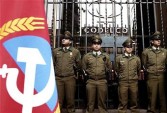 Police stand guard against protestors at the Codelco headquarters during a strike in Santiago, Chile, on June 26, 2007. 
