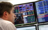 A Russian trader monitors the markets inside a private international investment banking firm in Moscow on October 9, 2008