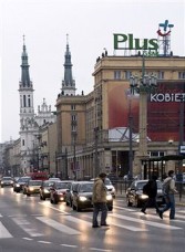 A  Plus GSM company sign sits on display above Plac Konstytucji in Warsaw, Poland, on Tuesday, April 12, 2011. 