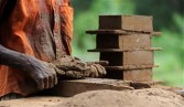 A Sri Lankan labour makes bricks by hand at a make-shift factory in Biyagamam, a suburb of the Sri Lankan capital Colombo, on July 17, 2011. 