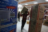 Iraqi man carries electrical goods