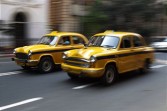 Taxis roaring ahead on the streets of Kolkata