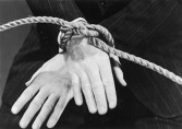 A man with his hands tied