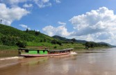 A "slow" boat cruises on the Mekong river
