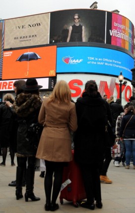 People watch the Burberry fashion show at Piccadilly Circus