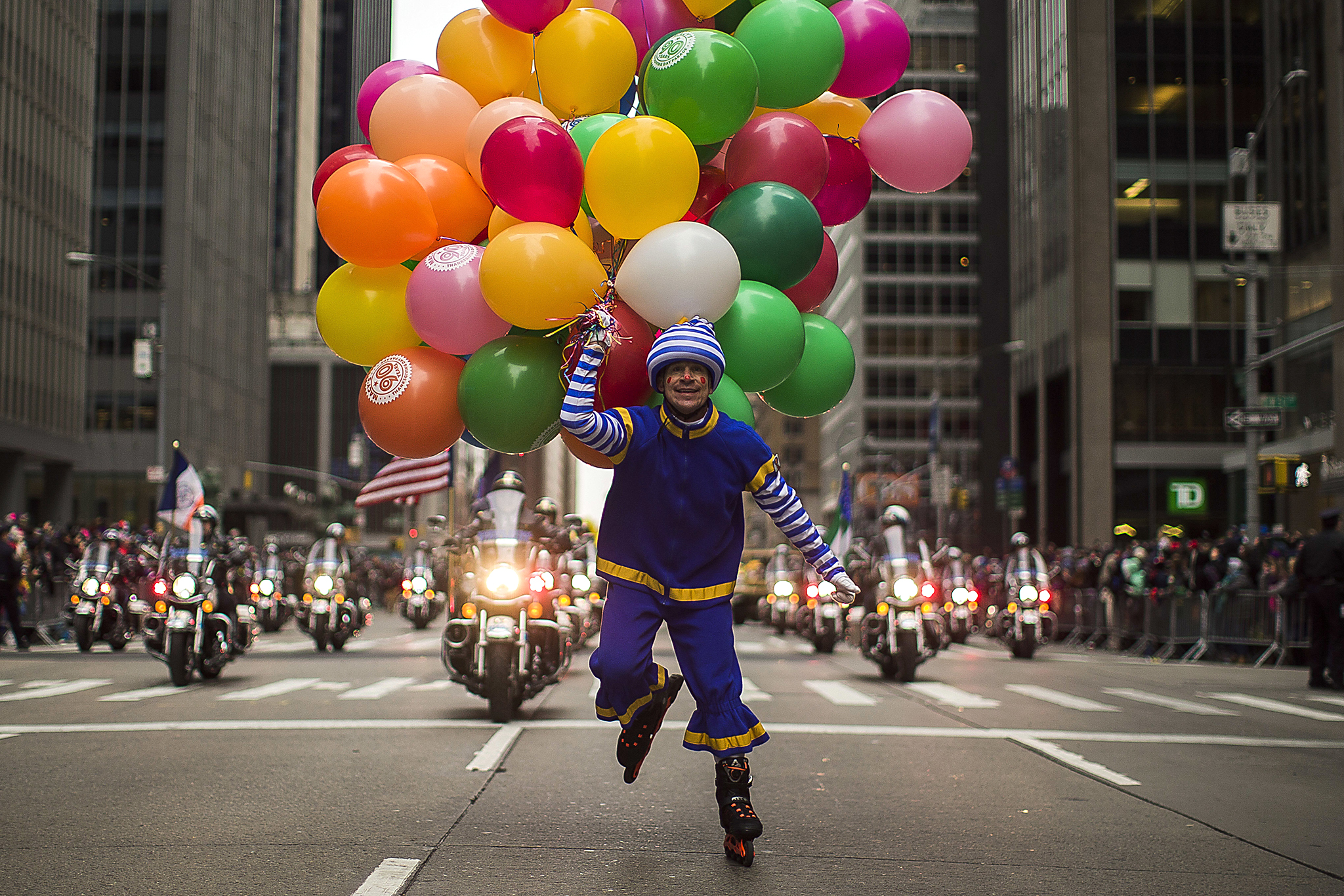 A performer carries balloons across Sixth Avenue during the Macy's Thanksgiving Day Parade, in New York, Thursday, Nov. 24, 2016. (AP Photo/Andres Kudacki)