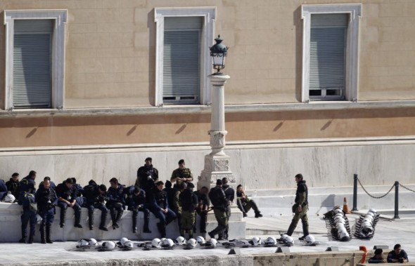 Riot policemen rest in front of parliament during an anti-austerity rally in Athens on October 20. Photo: Yiorgos Karahalis, Reuters