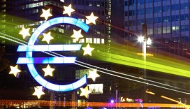 A tram passes the euro sign sculpture in front of the European Central Bank ( ECB) in Frankfurt, Germany. Photographer: Hannelore Foerster/Bloomberg