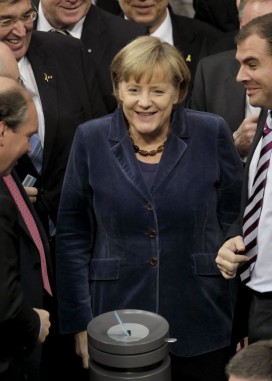 Angela Merkel waits to cast her ballot in the Bundestag. Photo: Michael Sohn/AP