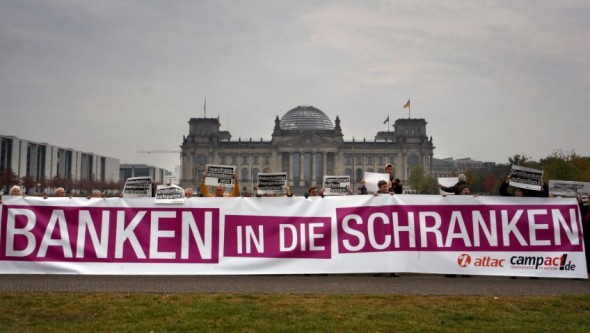 Activists hold a giant banner in front of the Reichstag building hosting the Bundestag in Berlin. Photo: Stephanie Pilick/AFP/Getty Images